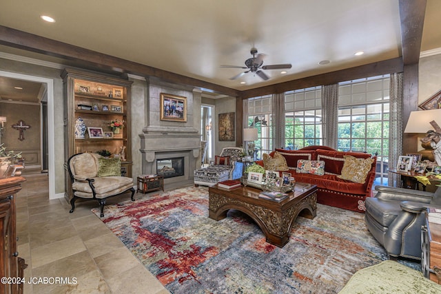 living room with ceiling fan and a fireplace