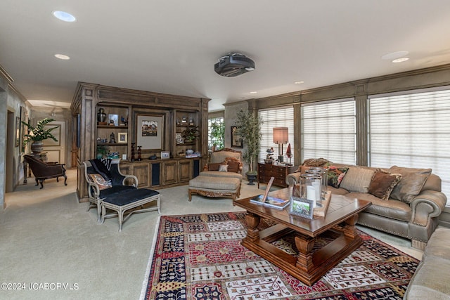 carpeted living room featuring ornamental molding