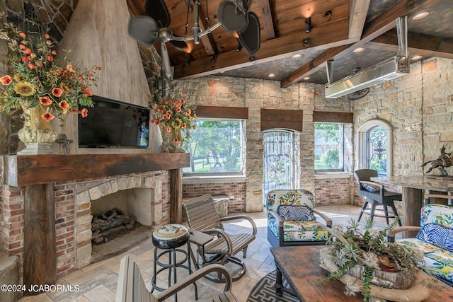 living room featuring a fireplace and beamed ceiling