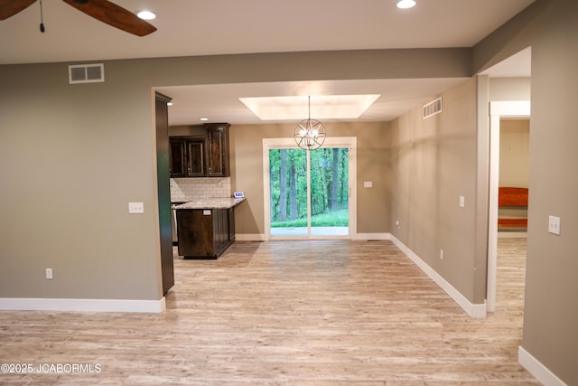 interior space featuring recessed lighting, baseboards, visible vents, and light wood finished floors