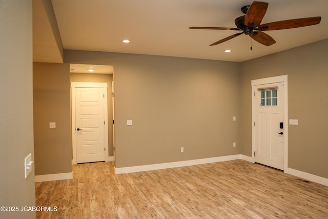 spare room with light wood-type flooring, a ceiling fan, baseboards, and recessed lighting
