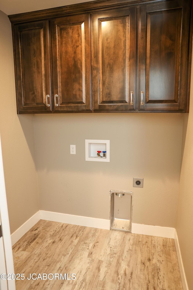 laundry area with cabinet space, washer hookup, baseboards, wood finished floors, and hookup for an electric dryer