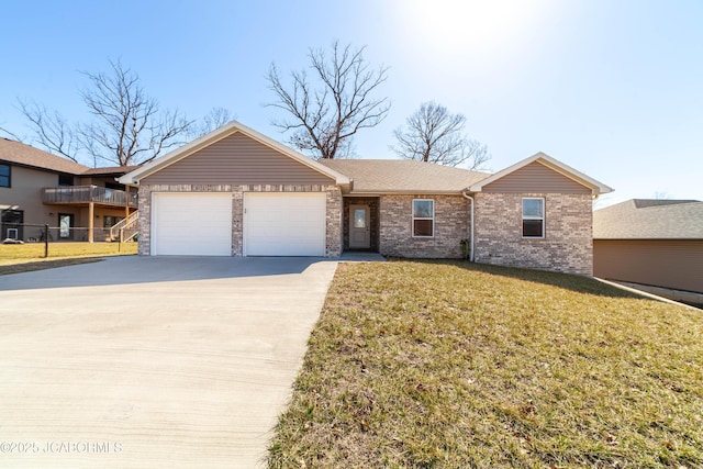 single story home featuring driveway, a front lawn, fence, an attached garage, and brick siding