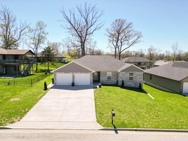 5405 Kenview Dr, Jefferson City, MO 65109 - view of front of property with a front yard, an attached garage, stone siding, and driveway