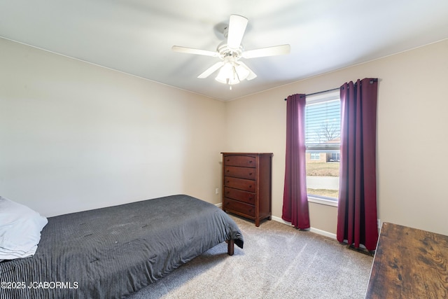 carpeted bedroom featuring baseboards and ceiling fan