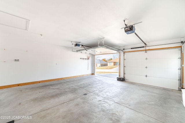 garage with baseboards and a garage door opener