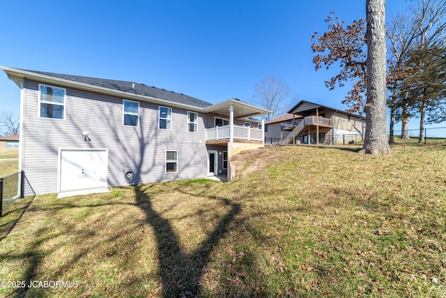 rear view of property featuring a yard and fence