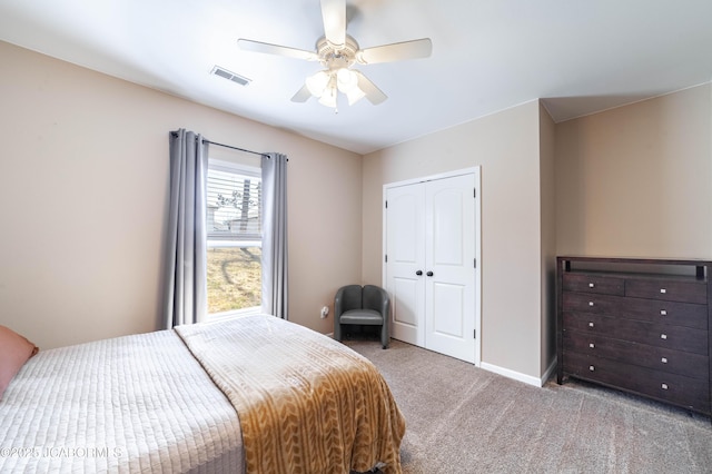 bedroom featuring visible vents, baseboards, carpet floors, a closet, and a ceiling fan