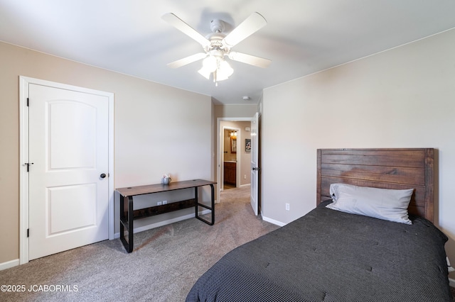 carpeted bedroom with ceiling fan and baseboards