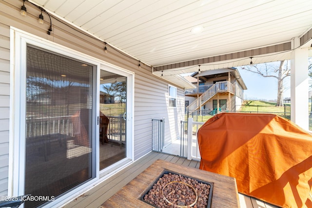 deck with a fire pit and a grill