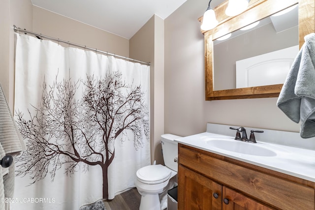 bathroom with vanity, curtained shower, and toilet