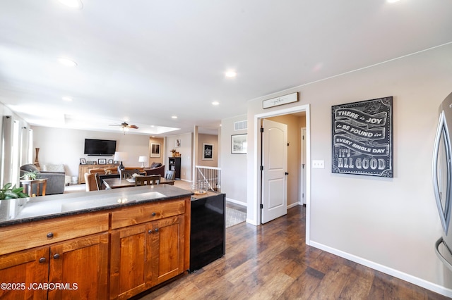 kitchen featuring visible vents, dark wood-type flooring, recessed lighting, brown cabinetry, and ceiling fan