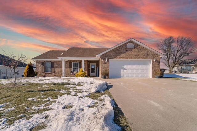 single story home featuring a garage and a front yard