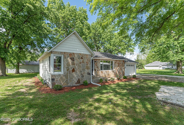 115 Middle St, Moberly, MO 65270 - view of front of home with stone siding, driveway, a garage, and a front lawn