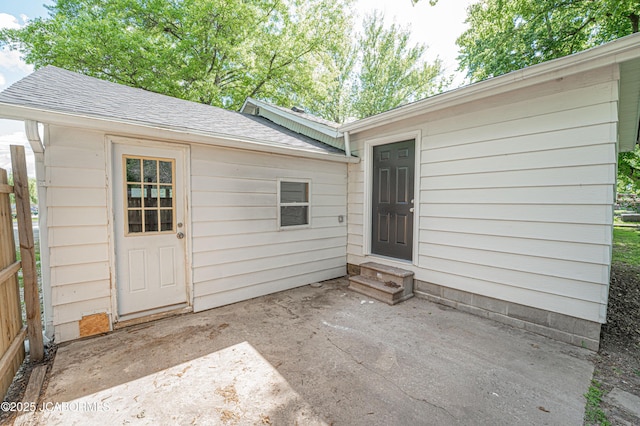 115 Middle St, Moberly, MO 65270 - property entrance featuring a shingled roof and a patio area