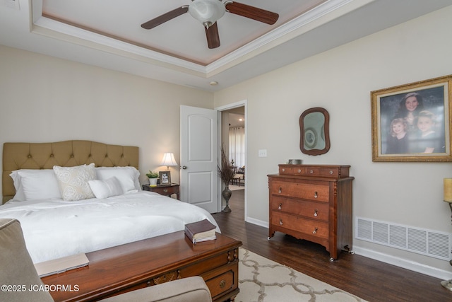 180 Venus St, Holts Summit, MO 65043 - bedroom featuring wood finished floors, baseboards, ornamental molding, a tray ceiling, and a ceiling fan