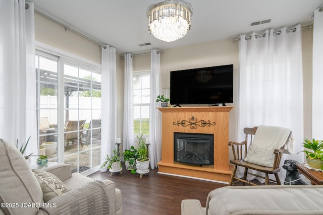 180 Venus St, Holts Summit, MO 65043 - living room featuring wood finished floors, a chandelier, and a glass covered fireplace