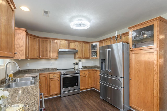 180 Venus St, Holts Summit, MO 65043 - kitchen with stainless steel appliances, a sink, under cabinet range hood, dark wood-style flooring, and brown cabinetry
