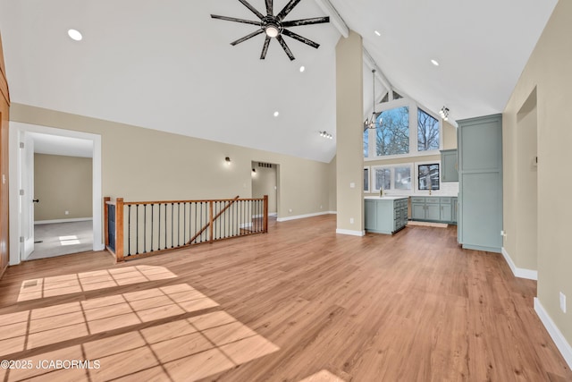 160 Ravenwood Dr, Camdenton, MO 65020 - unfurnished living room with high vaulted ceiling, light wood-type flooring, and baseboards
