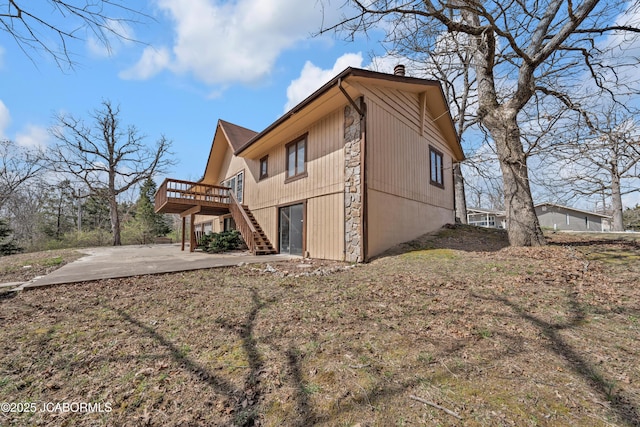 160 Ravenwood Dr, Camdenton, MO 65020 - exterior space featuring a patio, stairway, a wooden deck, a chimney, and stone siding