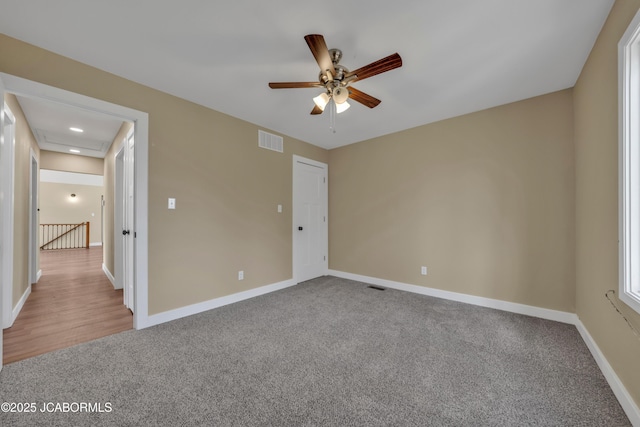 160 Ravenwood Dr, Camdenton, MO 65020 - unfurnished bedroom with visible vents, carpet floors, baseboards, and ceiling fan