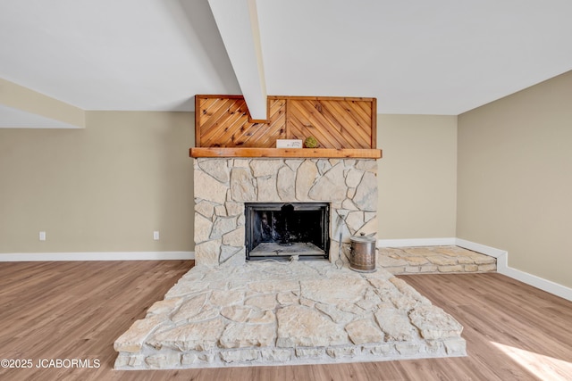 160 Ravenwood Dr, Camdenton, MO 65020 - details featuring baseboards, beam ceiling, wood finished floors, and a fireplace