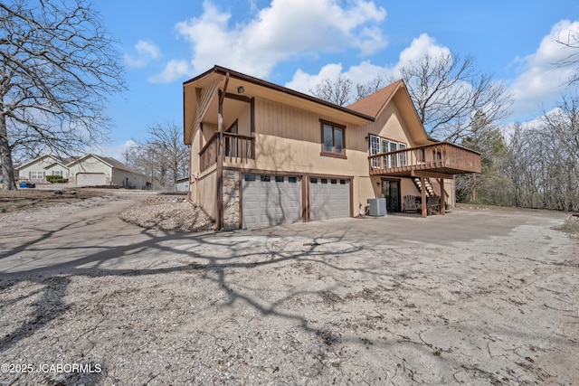 160 Ravenwood Dr, Camdenton, MO 65020 - view of side of property with stairway, driveway, an attached garage, and central AC