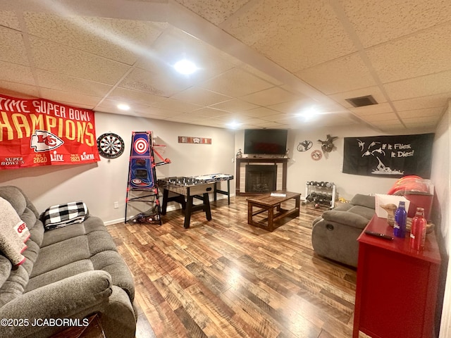 405 Lorene St, California, MO 65018 - living area featuring a paneled ceiling, wood finished floors, and a tiled fireplace