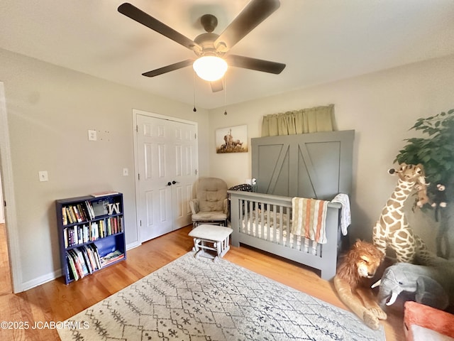 405 Lorene St, California, MO 65018 - bedroom featuring wood finished floors, a ceiling fan, a nursery area, and a closet