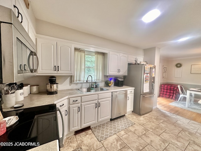 405 Lorene St, California, MO 65018 - kitchen featuring appliances with stainless steel finishes, light countertops, white cabinets, and light stone finish flooring