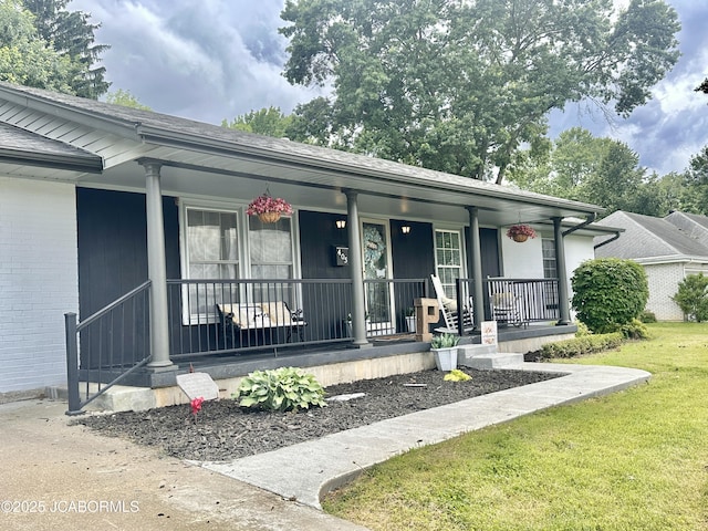405 Lorene St, California, MO 65018 - view of front of house featuring covered porch, a front yard, and brick siding