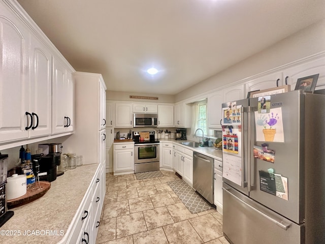 405 Lorene St, California, MO 65018 - kitchen featuring appliances with stainless steel finishes, light countertops, and white cabinetry