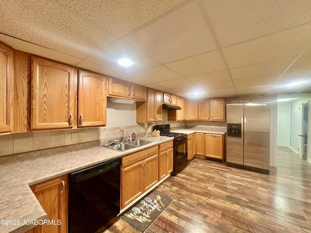 405 Lorene St, California, MO 65018 - kitchen featuring black appliances, wood finished floors, light countertops, and a drop ceiling