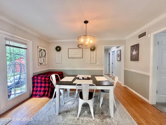 405 Lorene St, California, MO 65018 - dining space with wood finished floors, a chandelier, and ornamental molding