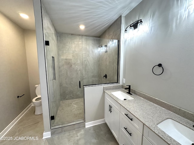 bathroom featuring vanity, an enclosed shower, and toilet