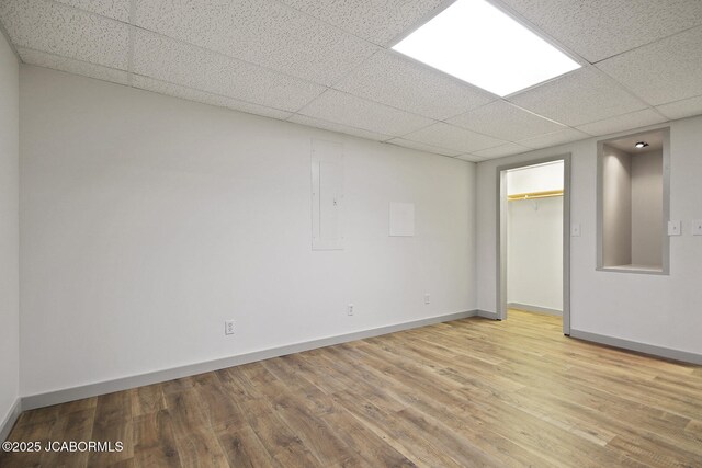 140 County Road 412, Fayette, MO 65248 - unfurnished room with light wood-style flooring, a drop ceiling, baseboards, and electric panel