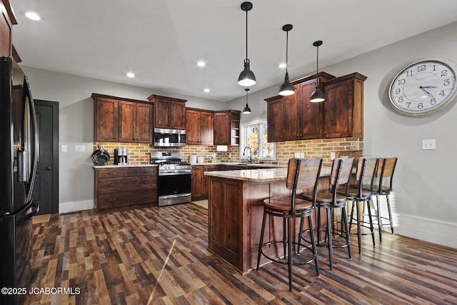 140 County Road 412, Fayette, MO 65248 - kitchen with stainless steel appliances, dark wood finished floors, a peninsula, a sink, and recessed lighting