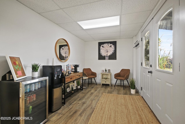 140 County Road 412, Fayette, MO 65248 - sitting room featuring a drop ceiling, beverage cooler, and wood finished floors