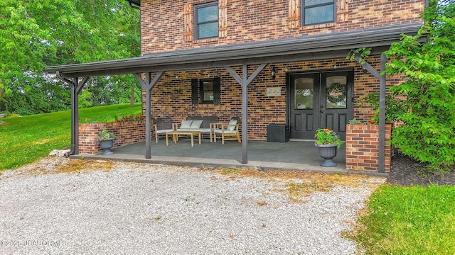 140 County Road 412, Fayette, MO 65248 - property entrance featuring brick siding, a porch, and a lawn