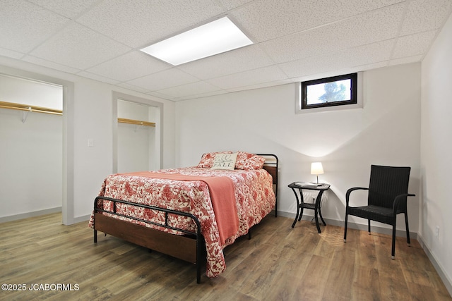 140 County Road 412, Fayette, MO 65248 - bedroom featuring wood finished floors, a paneled ceiling, and baseboards