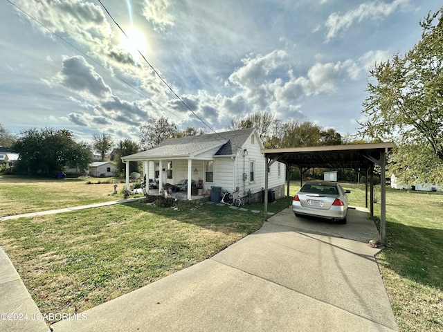 view of front facade with a carport, a porch, and a front lawn