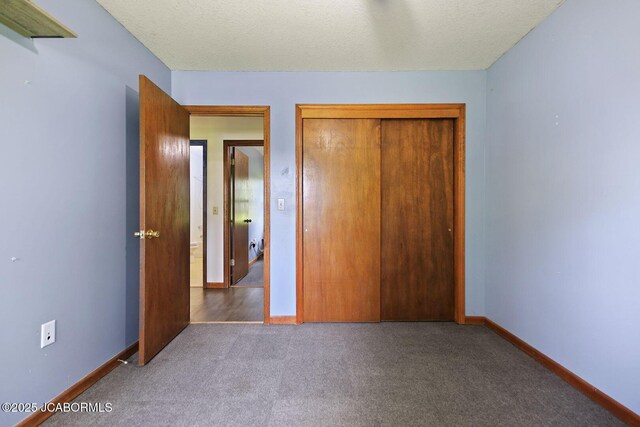3861 State Road H, Fulton, MO 65251 - unfurnished bedroom with carpet, a closet, and a textured ceiling