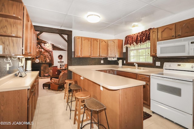 9542 Osage Ct, Williamsburg, MO 63388 - kitchen with white appliances, light countertops, a kitchen bar, and light tile patterned floors