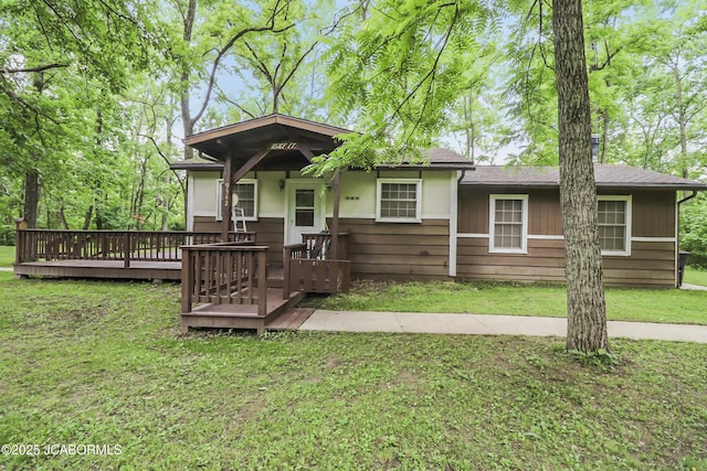9542 Osage Ct, Williamsburg, MO 63388 - view of front of house with a front yard and a wooden deck