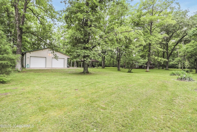 9542 Osage Ct, Williamsburg, MO 63388 - view of green lawn featuring a detached garage and an outbuilding