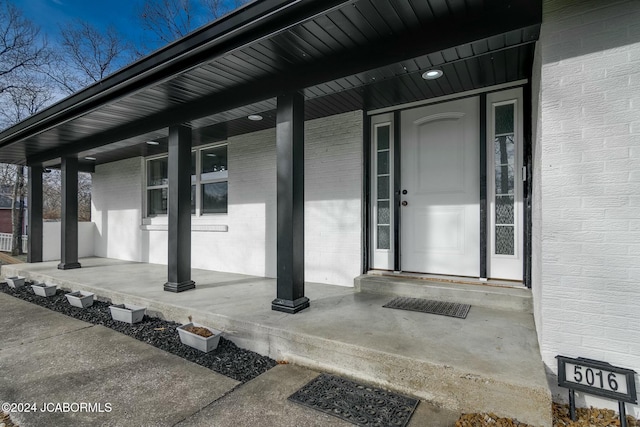 view of exterior entry with covered porch