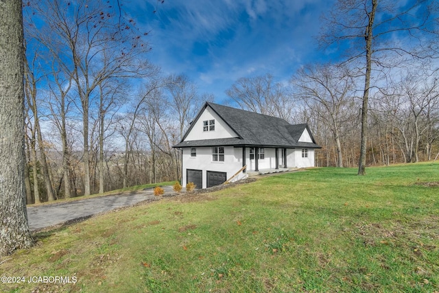 view of front of house featuring a front yard and a garage