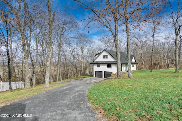 view of front of house with a garage and a front yard