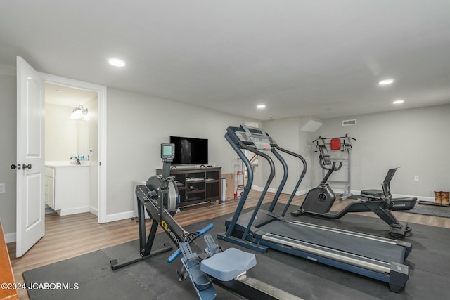 exercise area with wood-type flooring