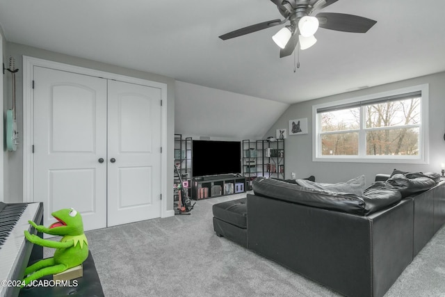 carpeted living room with vaulted ceiling and ceiling fan